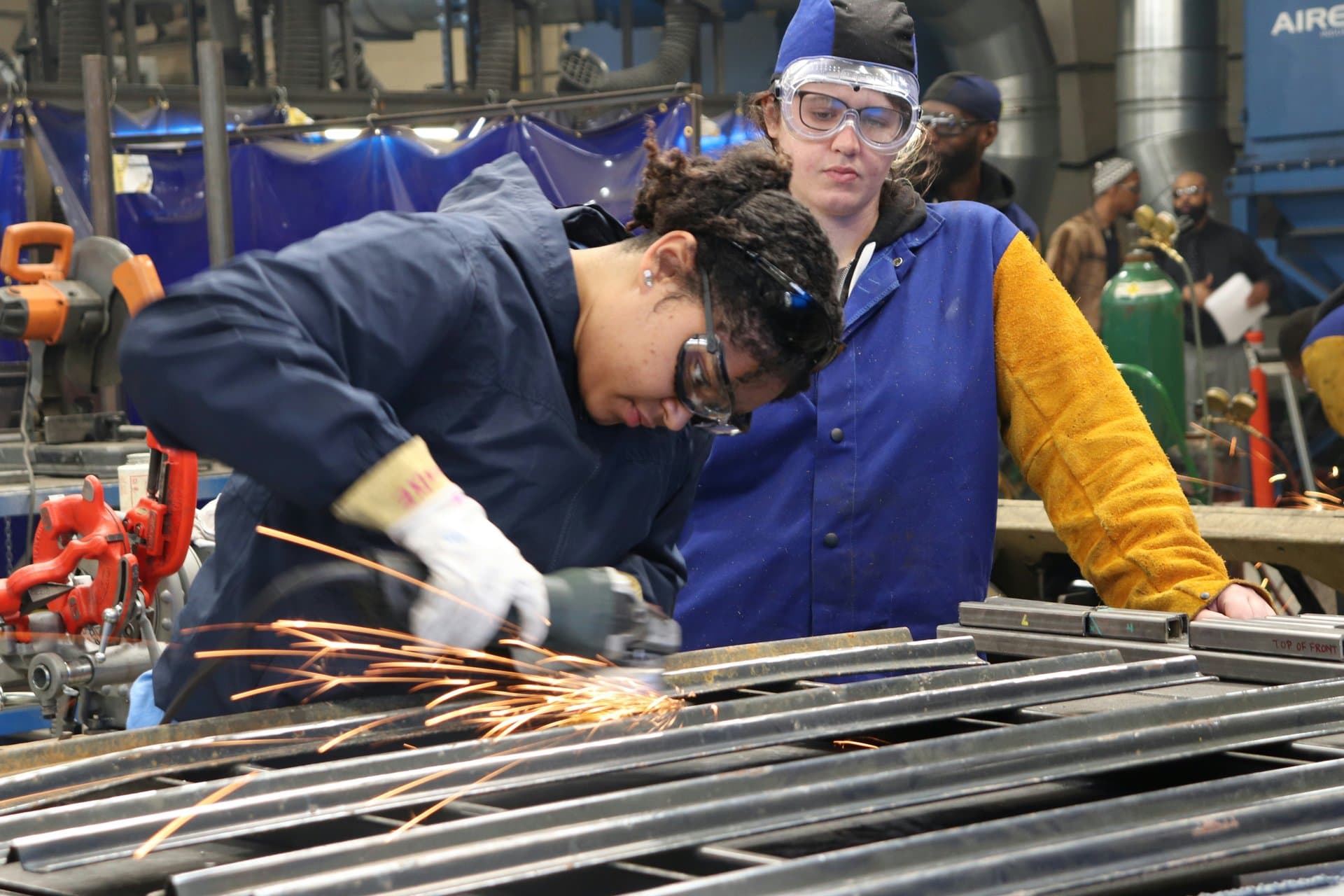 a woman welding metal